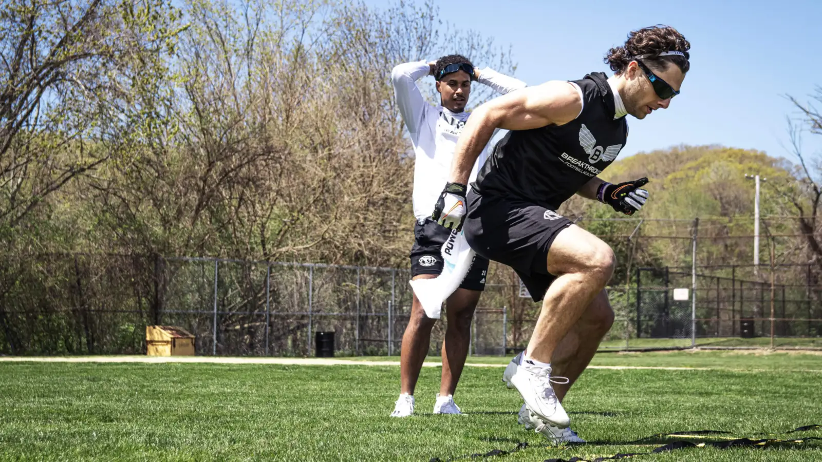 An althete training footwork with a trainer